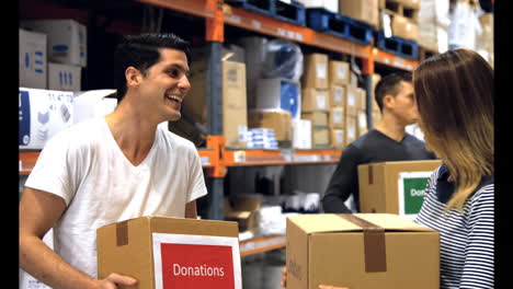 men and woman carrying donation box