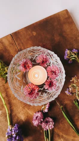 floral arrangement with candle and water