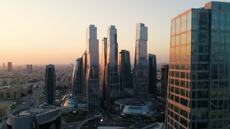 a stunning aerial view of modern skyscrapers at dusk, highlighting innovative architecture and urban development in a dynamic city landscape