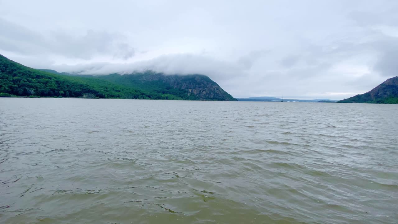 The Hudson River in the Hudson Valley in New York State, on a rainy day, with clouds overhead. The Hudson valley is in the larger Appalachian mountain range