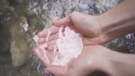 Hands-taking-water-from-the-stream.-palming.-Slow-motion.