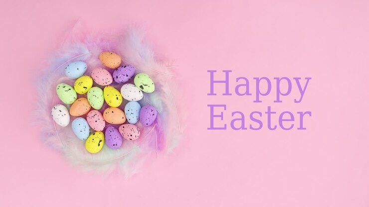 Happy Easter write next to nest with vibrant eggs on pastel pink background. Stop motion flat lay