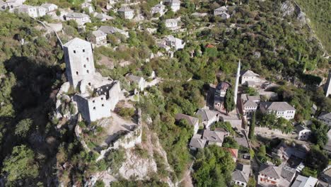 aerial: drone flying by the tower in počitelj fortress, in bosnia and hercegovina. circular shot