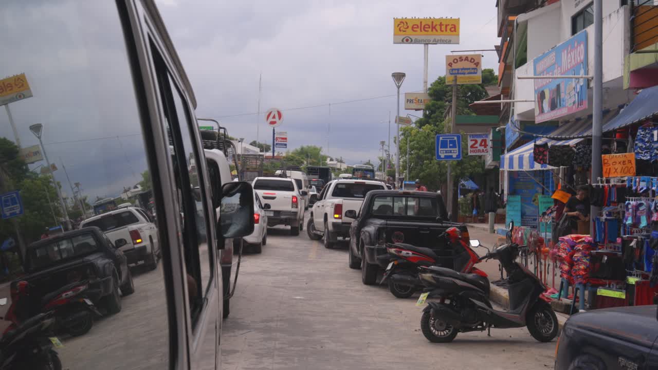 Car traffic in Mexico village, authentic town in Latin America, view from taxi