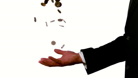 businessman catching falling coins in hand