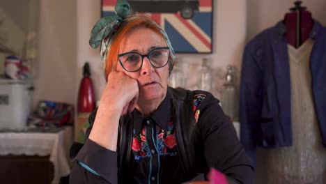 an modern, trendy older lady sitting talking in a home setting