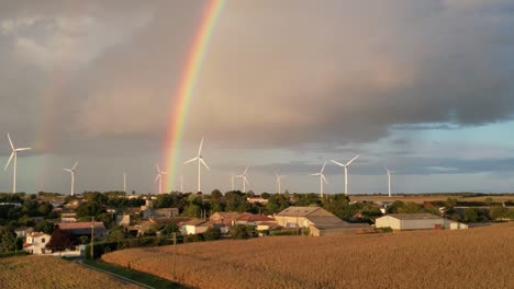 Turbinas-Eólicas-Girando-Contra-Un-Cielo-Tormentoso-Con-Un-Arco-Iris