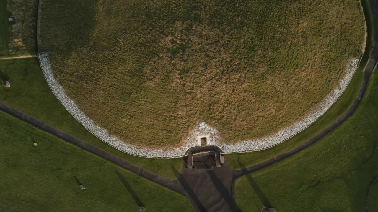 Grassy Top Of Newgrange, Prehistoric Monument At Sunrise In County Meath, Ireland. - aerial overhead shot