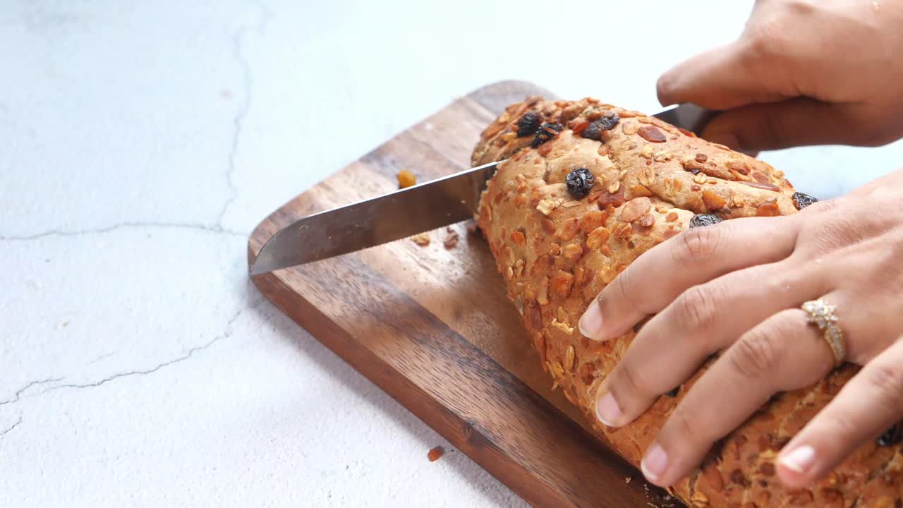 Cutting a loaf of raisin bread