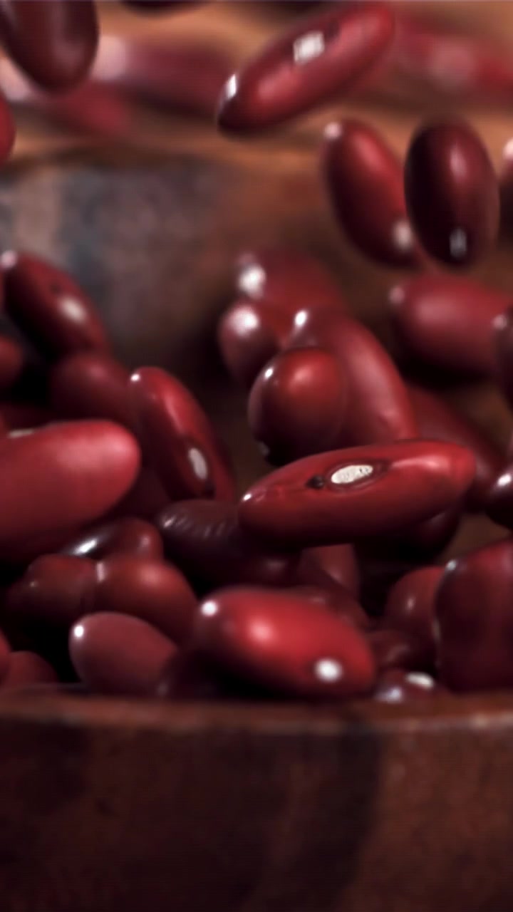 Red Kidney Beans Falling into a Wooden Bowl in Slow Motion