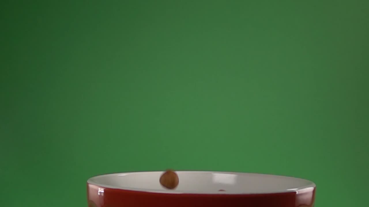 Japanese style peanuts falling on a plate