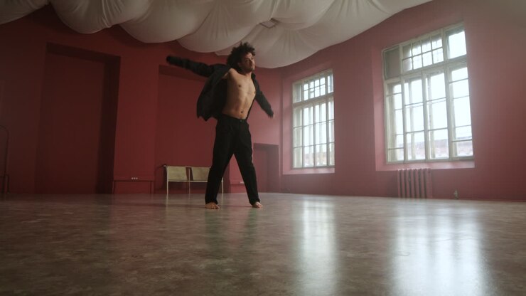 Young man dancing in a classroom
