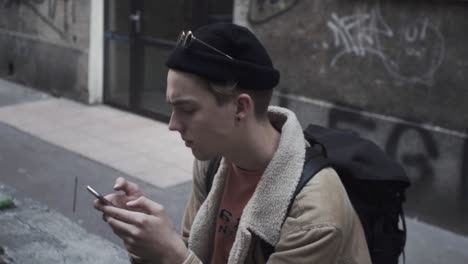 young man reading message on his mobile phone