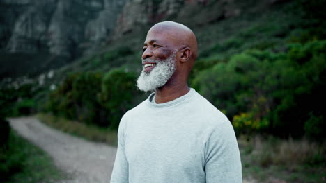 older man with gray beard smiling outdoors