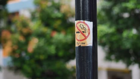 no smoking sign on a metal pole