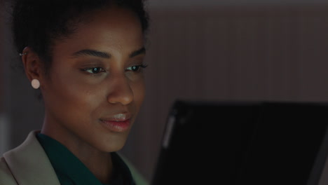 beautiful business woman using tablet computer working late in office browsing information looking at data on digital touchscreen