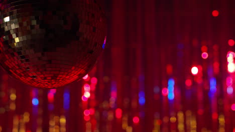 close up of mirrorball in night club or disco with flashing strobe lighting and sparkling lights in background 2