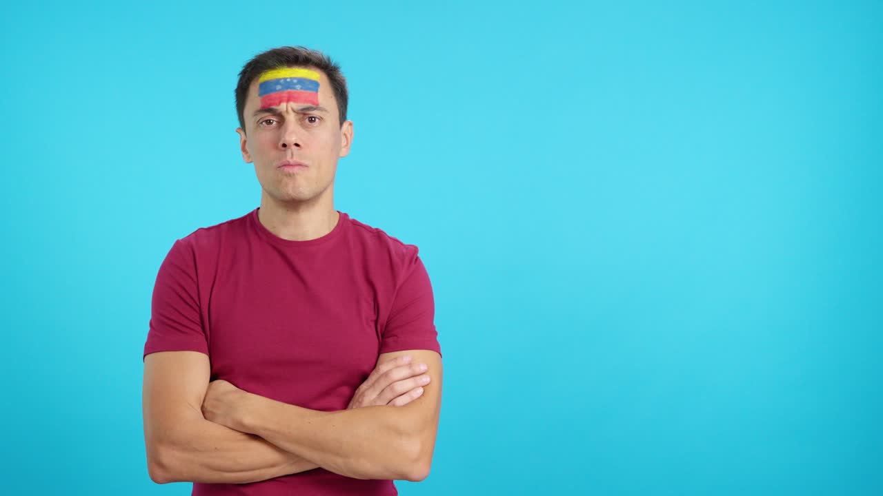 Dignified and serious man with venezuelan flag painted on face