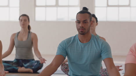 Clase-De-Yoga-De-Jóvenes-Multiétnicos-Practicando-La-Postura-Del-Loto-Disfrutando-De-La-Meditación-Consciente-Sentados-En-El-Gimnasio