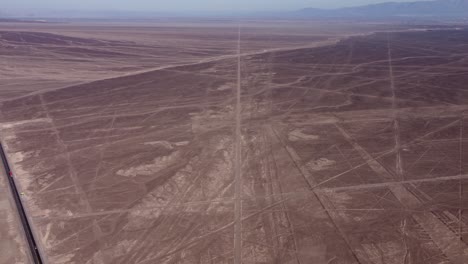 aerial video of the flat arid desert plateau that holds the famous nazca lines. drone flies high above the countless long linear geoglyphs and many more symbols. located in nazca, peru