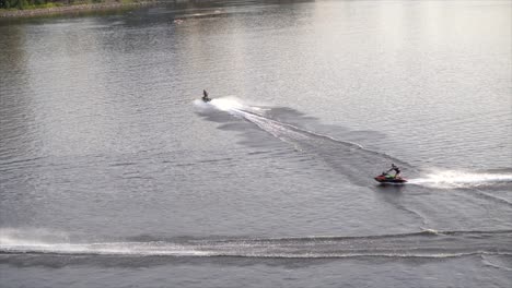 people riding jet-skies in river
