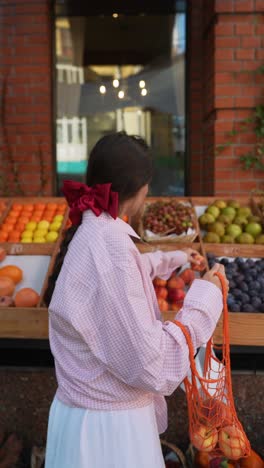 woman shopping for fruit at a market