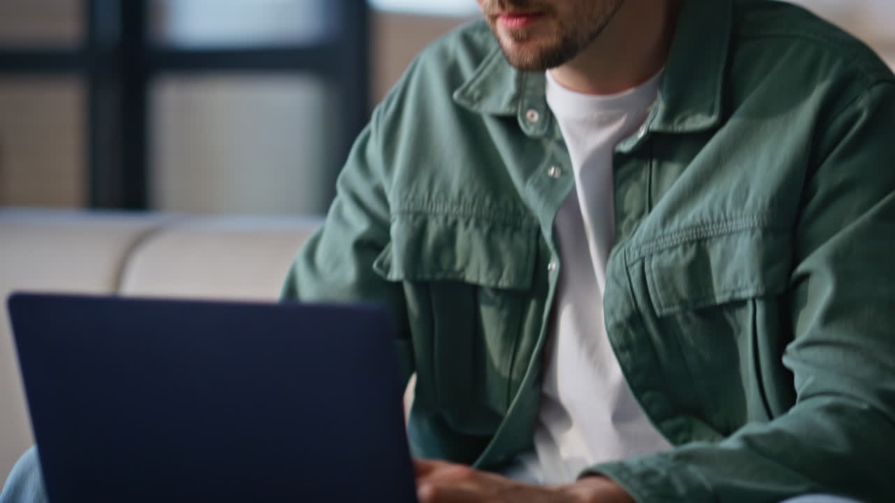 Pensive man thinking work at spacious apartment closeup. Frowning guy texting