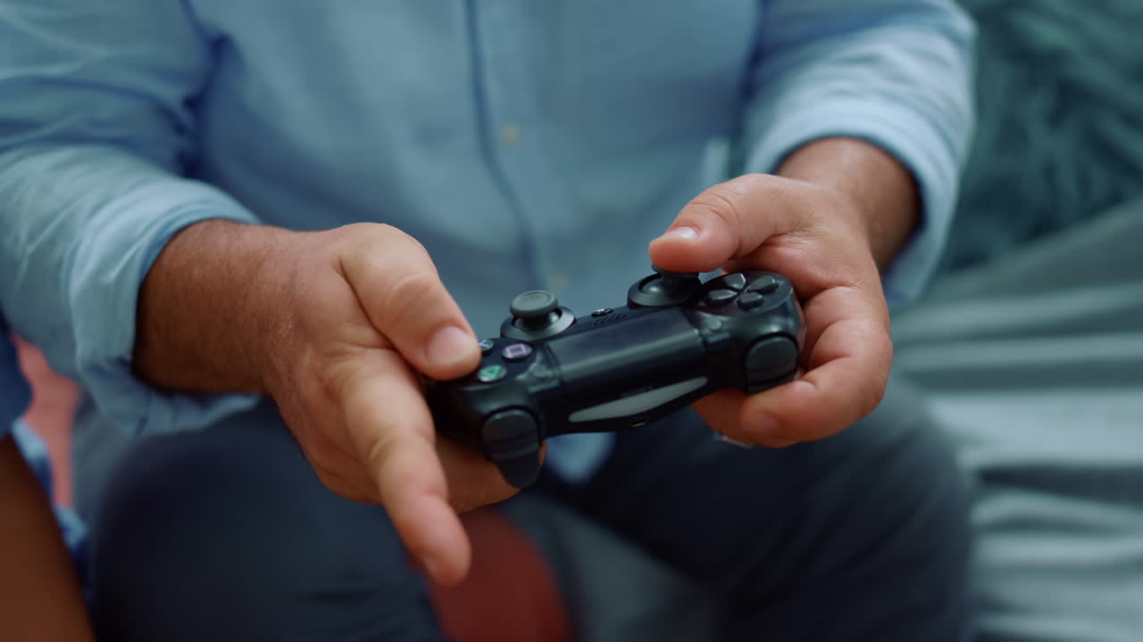 Senior man hands playing game with joystick. Male hands using gamepad for game
