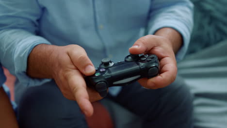 senior man hands playing game with joystick. male hands using gamepad for game