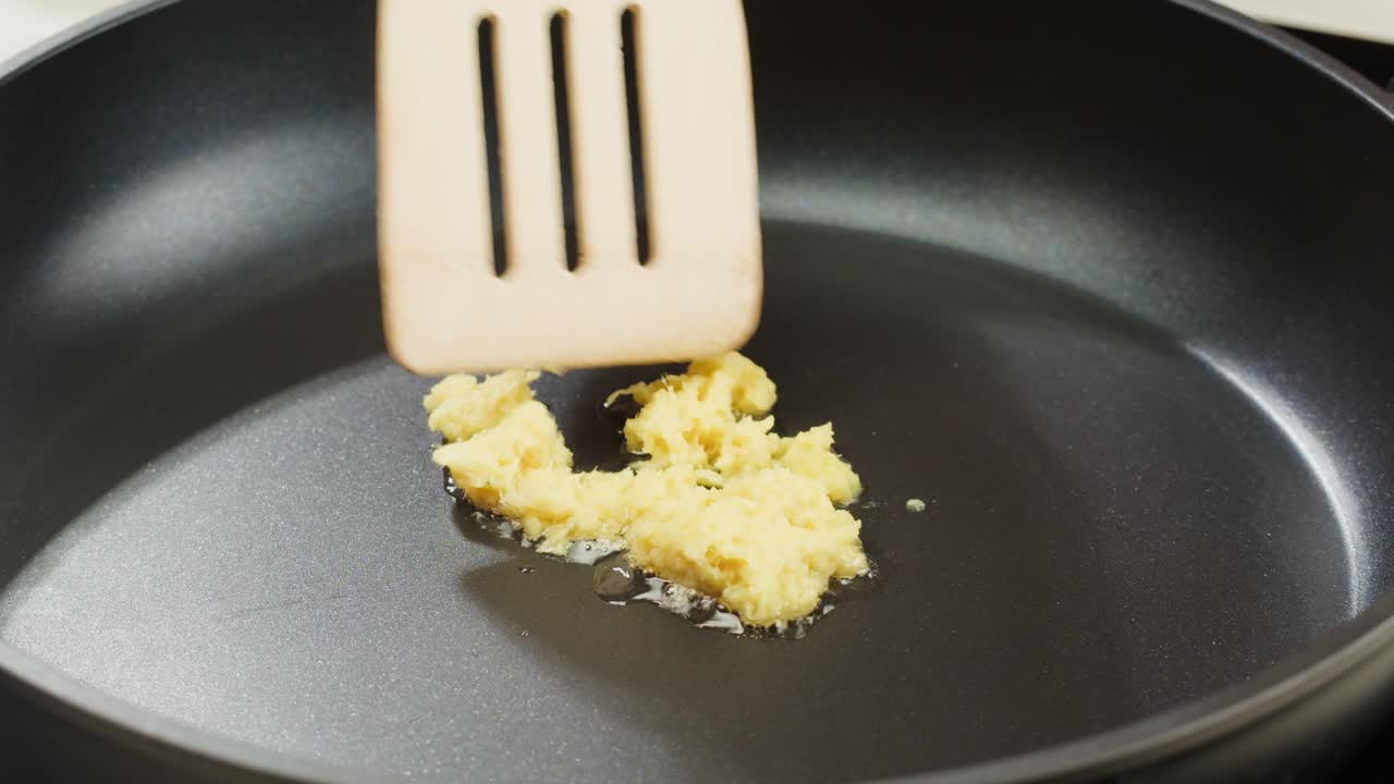 Peeled and Finely Chopped Ginger or garlic Root, Diced ginger on a wooden cutting board prepared for stew grill