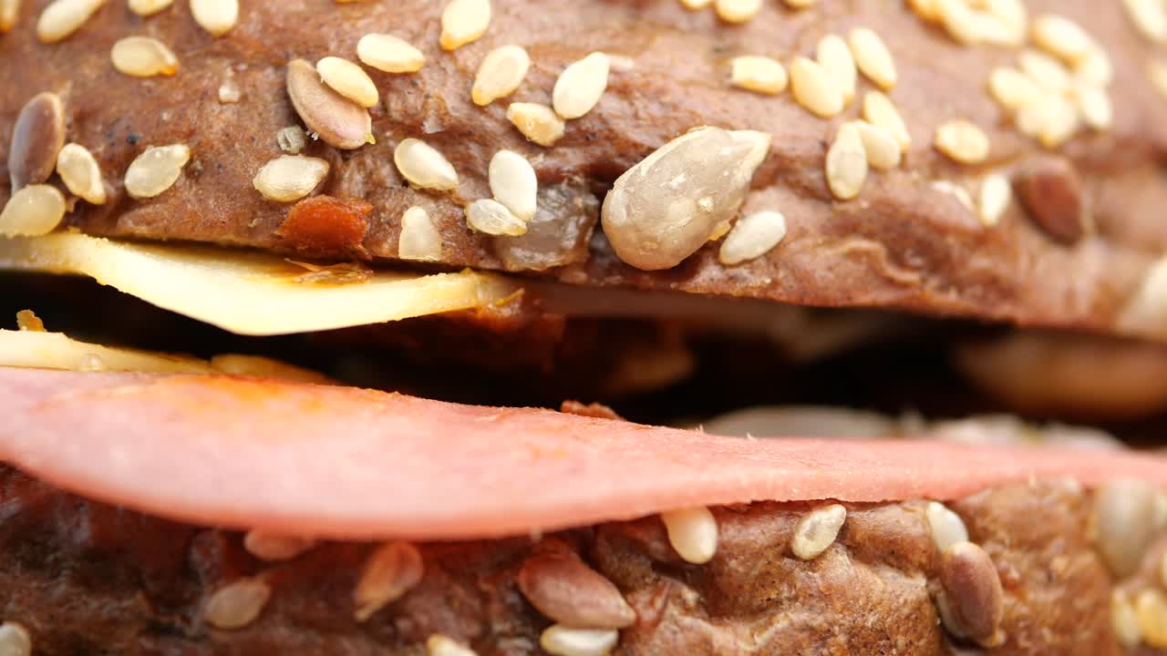 Close-up of a ham and cheese sandwich on seeded bread