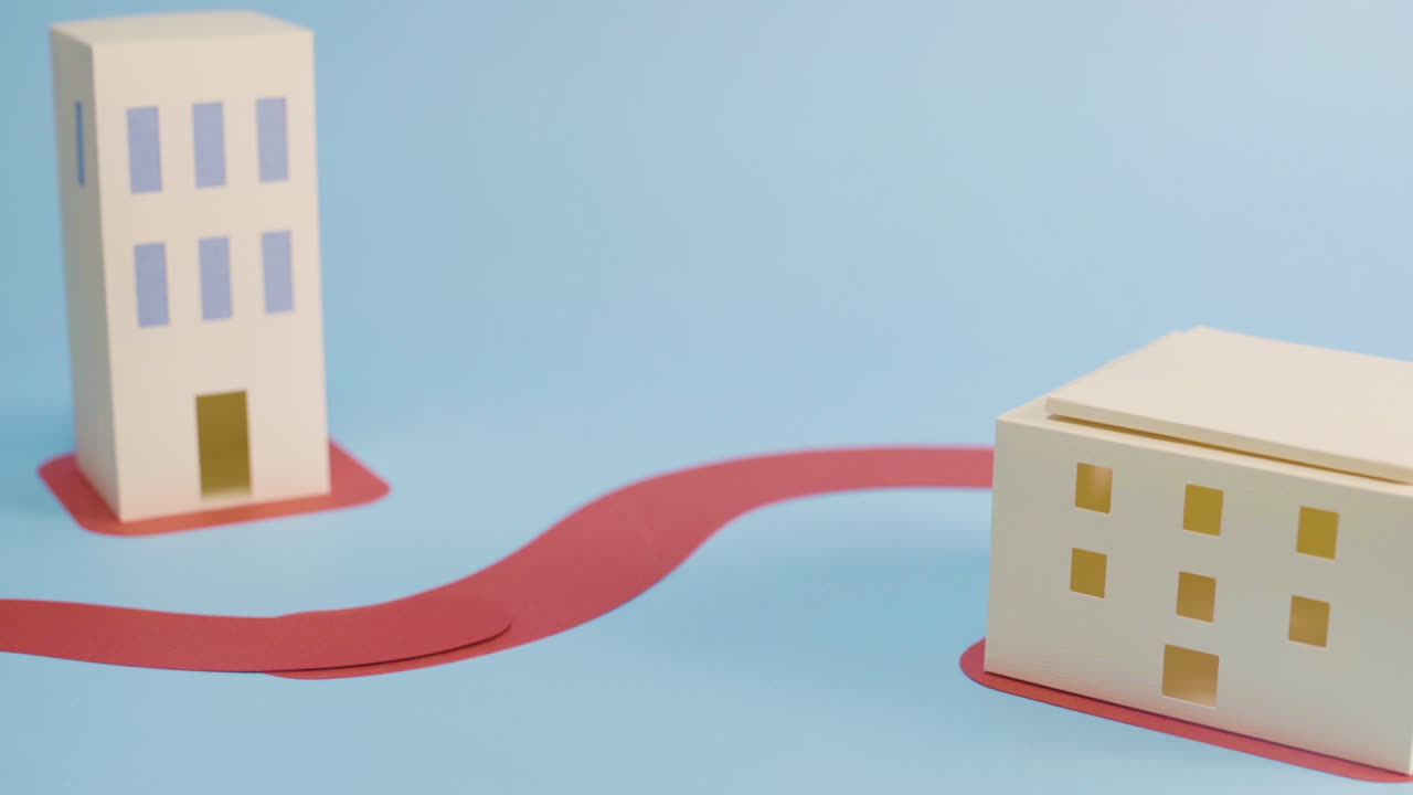 White paper buildings representing modernization, blue background - close up pan