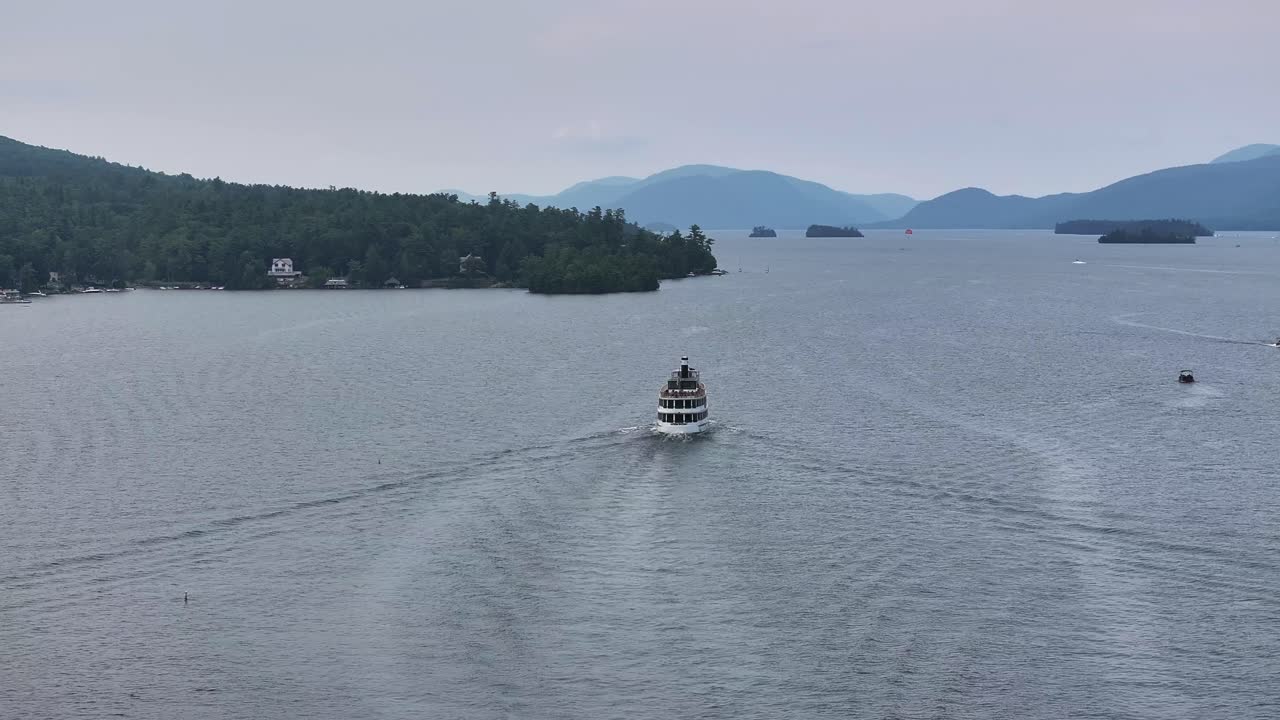The Adirondack cruise ship heading out in overcast day drone view in 4K