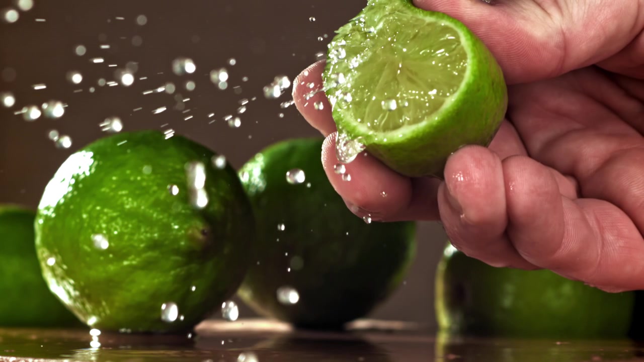 Slow Motion Water Splashing on a Fresh Green Lime