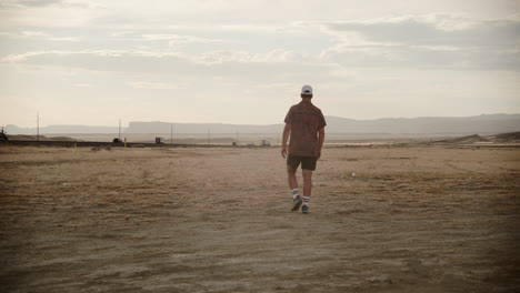 man walks alone in moab utah