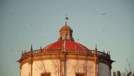 medium shot, scenic view of mosteiro da serra do pilar tower in porto, portugal, birds flying above the tower in the background