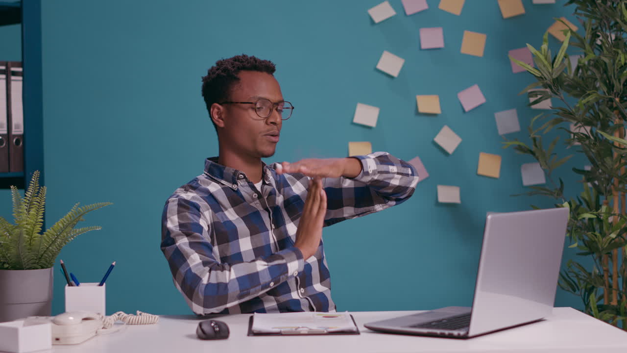 Overworked employee showing timeout gesture with hands