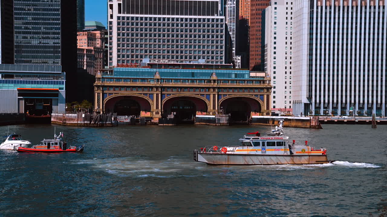 New York, USA, 9 August 2025: Boats near Staten Island Ferry Terminal in New York. Rescue boats and yachts near the historic Staten Island Ferry Terminal surrounded by skyscrapers of Lower Manhattan