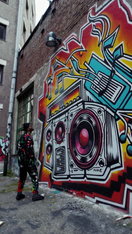 graffiti artist working on a mural of a boombox