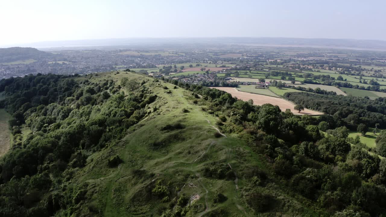 AERIAL - Beautiful hills, Uley, Cotswolds, England, forward spinning shot tilt down