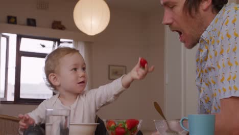 Caucasian-father-having-fun-with-baby-at-home