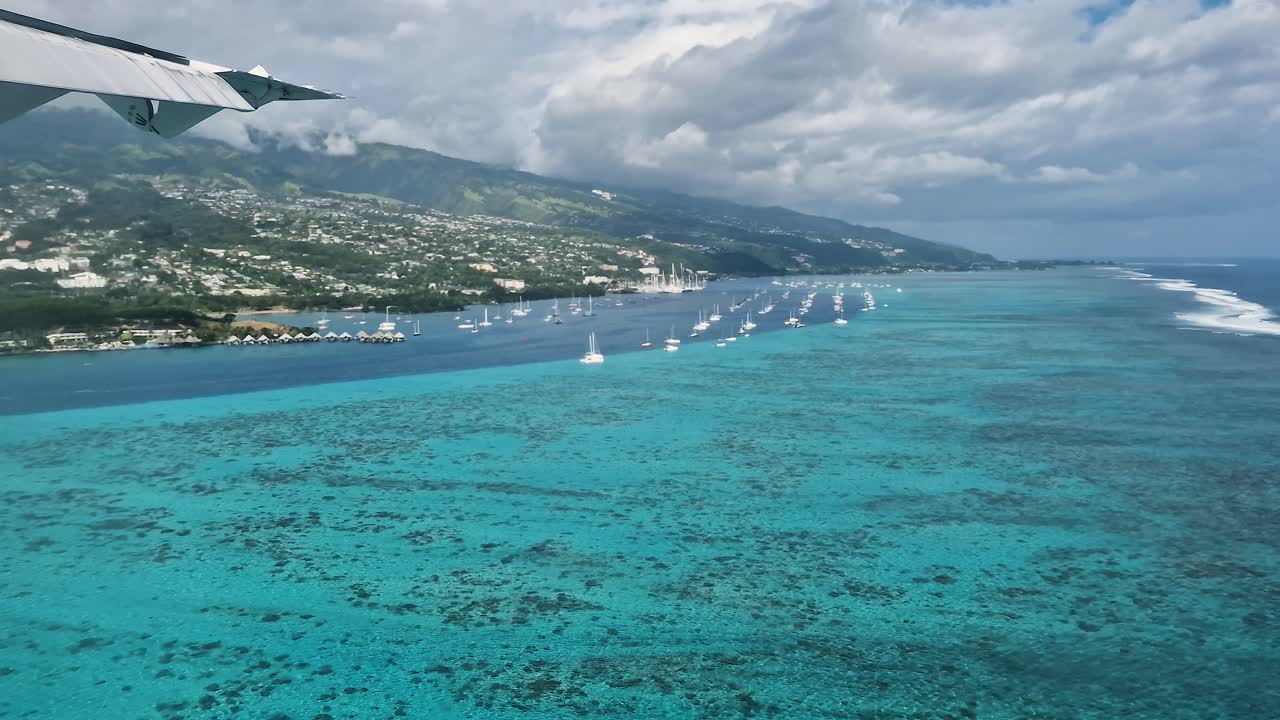 Tahiti Island Coastline and Lagoon, French Polynesia. Airplane Passenger POV Before Landing on Papeete International Airport