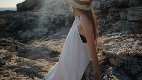 woman relaxing on rocks by the sea