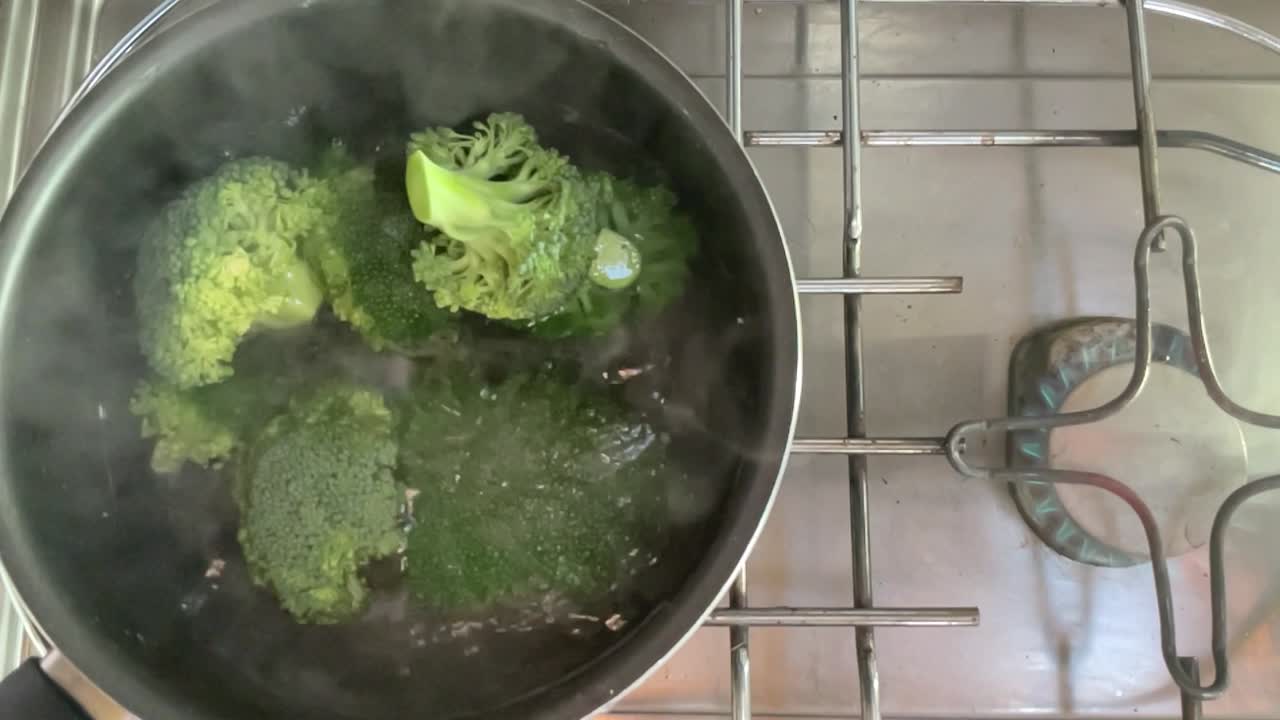 Slow motion broccoli vegetable healthy food in hot water pot