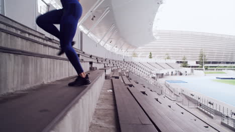 woman running up stadium stairs