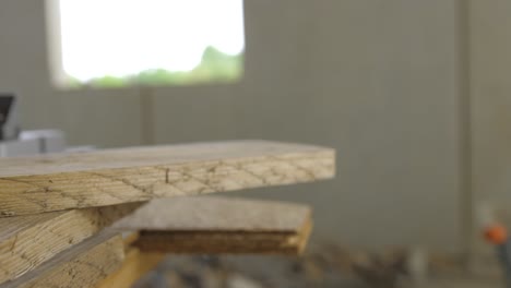 slow motion close up video of a construction worker grabbing a piece of wodo