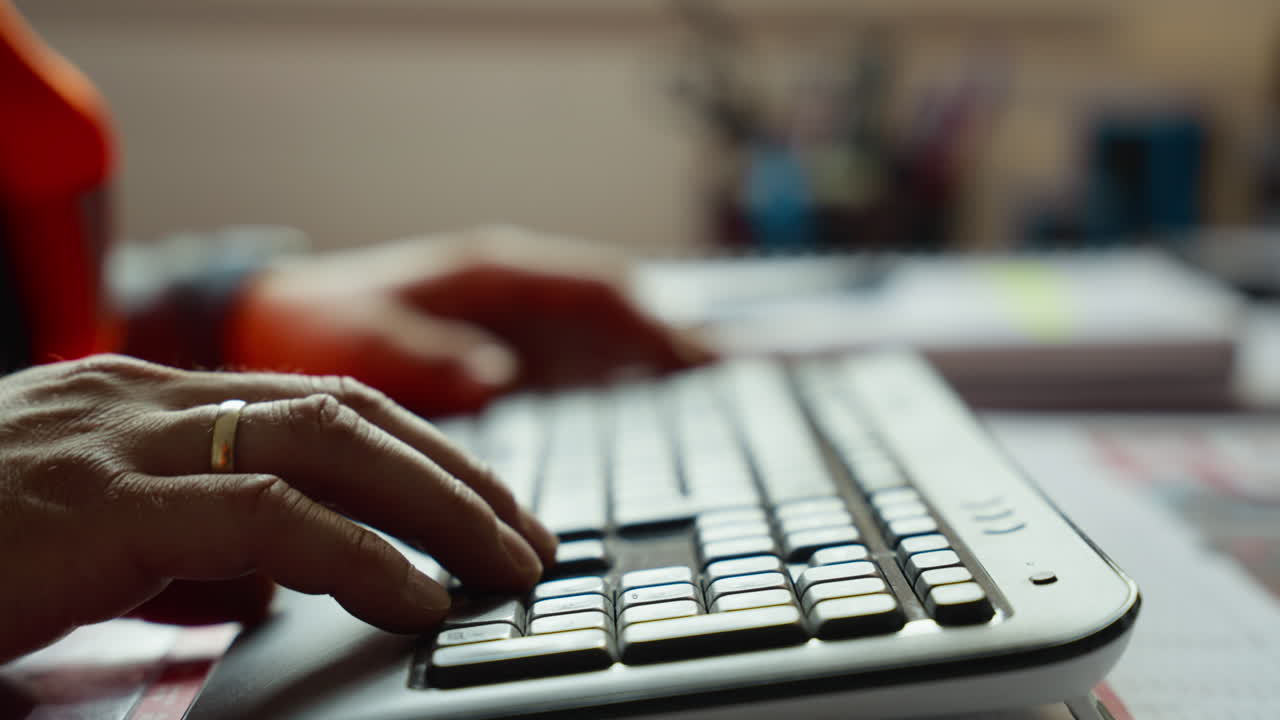 Hands of industry worker typing on a computer keyboard. Perfect for office productivity videos or tech tutorials