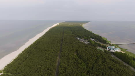 drone shot flying backwards over the hel peninsula, sunny day in poland