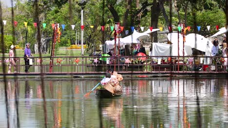 a boat rows across a serene park lake