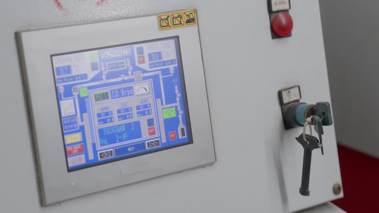 CNC Machine Operator Turning Key And Programming Computer System During Manufacturing Process.